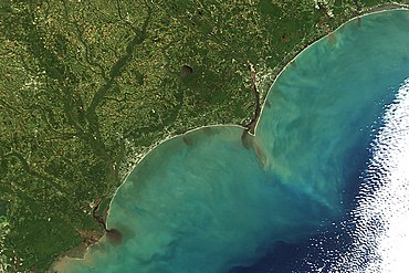 Variations in the concentration of colored dissolved organic matter as seen from space. The dark brown water in the inland waterways contains high concentrations of CDOM. As this dark, CDOM-rich water moves offshore, it mixes with the low CDOM, blue ocean water from offshore. Sediment off the Carolinas on October 9, 2016.jpg
