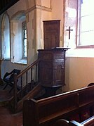 Jacobean pulpit showing sounding board behind the preacher's head.