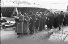 Jewish prisoners are issued food on a building site at Salaspils concentration camp, Latvia, in 1941. Bundesarchiv Bild 101III-Duerr-053-29, Lettland, KZ Salaspils, Essensausgabe.jpg