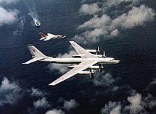 An F-8 of Oriskany intercepts a Tu-95 'Bear-B'. F-8J Crusader of VF-194 escorting a Soviet Tu-95 over USS Oriskany (CVA-34) on 25 May 1974.jpg