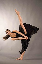 A ballet dancer performs a standing side split