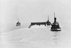 A Conundrum is towed across the English Channel laying out pipe to Cherbourg IWM-T-29-PLUTO-Conundrum-at-sea.jpg