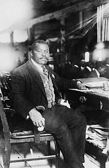 Garvey seated at a desk