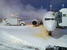 Deicing an aircraft during a snow event 2008 aircraft deicing at gate.jpg