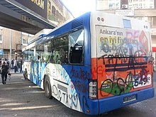 A public bus damaged and vandalized with graffiti text calling Erdogan a "son of a bitch" Ankara Taksim eylemi2.jpg