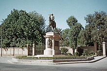 Equestrian statue in front of gated property