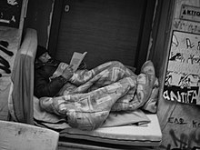 Homeless person in Athens Homeless, reading; Athens, Exarchia (15824614293).jpg