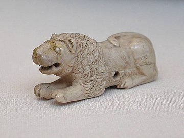 Old Kingdom gaming piece of ivory. Set of 6, 3 lions, and 3 bulldogs; Abu Rouash, Tomb M, 1st Dynasty, 3.5 × 6.5 cm, Cairo Museum[4]