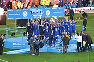 Members of the Leicester City team lifting the Premier League trophy
