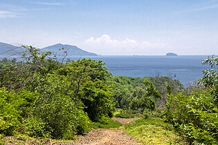 View east from the hill on the western side of the port: Candidasa over the wider bay, and the rock of Gili Bia[16] jutting out in the Lombok Strait