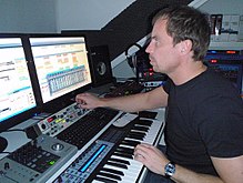 Music production in the 2000s using a digital audio workstation (DAW) with an electronic keyboard and a multi-monitor set-up Peter Francken in his studio.jpg