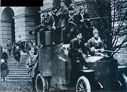 Red Guards in front of the Smolny Institute in Petrograd, center of the October Revolution of 1917 in Russia, which had an enormous impact on the workers' movement throughout the world. Bronevik u Smol'nogo 1917.JPG