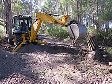 Western Australia Parks and Wildlife Conservation Employee changing a culvert pipe at Dombakup Block, Warren State Forest in May 2015. Culvert construction Dombakup V-2015.JPG