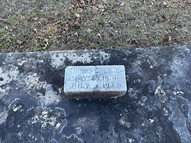 A gravestone reading "Norris F. Dendy, May 29, 1900 to July 4, 1933"