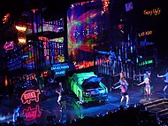 L'original i la mostra revisada es va iniciar amb una club remix de "Dance in the Dark". En la sèrie original (esquerra),Gaga aparèixer darrere de malla de llum, mentre que el programa revisat (dret) presentar una escena de Nova York la nit.