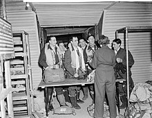 51 Squadron Halifax crew hand in their parachutes after a raid on the Ruhr 51 Squadron Halifax crew return from Ruhr WWII IWM CH 10293.jpg