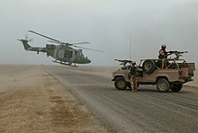 British forces south of Basra Airport, Iraq, November 2003 Army Air Corps Lynx linking up with RAF regiment vehicle patrol. MOD 45142954.jpg