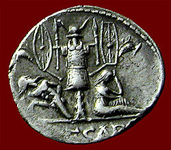 Reverse side of a denarius issued by Julius Caesar, depicting a military trophy with a nude captured Gaul and a female personification of defeated Gallia; Venus is pictured on the obverse Caesar venustrophy3b.jpg