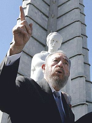 Castro, in 2002, beneath a statue of José Martí
