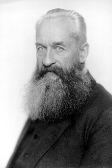 Head and shoulders black-and-white portrait of an elderly Lvov with pale eyes and a large grey beard