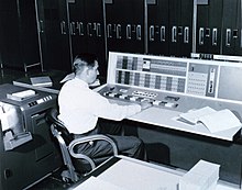 A meteorologist at the console of the IBM 7090 in the Joint Numerical Weather Prediction Unit, c. 1965 IBM 7090 console used by a meteorologist, 1965.jpg