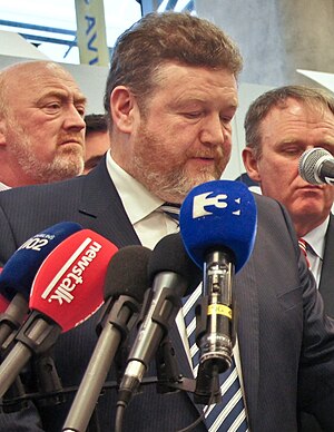James Reilly (in front of microphones).