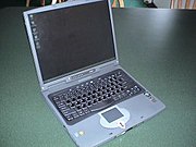A silver Acer laptop with touchpad