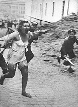 Jewish woman chased by men and youth armed with clubs during the Lviv pogroms, July 1941 Lviv pogrom (June - July 1941).jpg