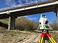 Total station facing a bridge pile for survey