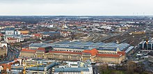 Leipzig Hauptbahnhof is the main hub of the tram and railway network and the world's largest railway station by floor area. Bahnhof Leipzig von Panorama Tower 2013.jpg