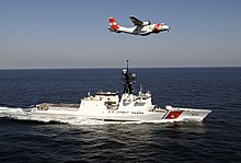 USCG National Security Cutter USCGC Bertholf (WMSL-750) and an EADS HC-144 Ocean Sentry Bertholf and Plane (2259190479).jpg