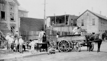 A family evacuating their house after it was vandalized in the Chicago race riot ChicagoRaceRiot 1919 wagon.png