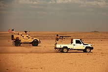 U.S. Green Berets and Revolutionary Commando Army rebels on a joint patrol near al-Tanf, 29 April 2020 Green Beret, Maghaweir al-Thowra patrol southern Syria, 29 April 2020.jpg