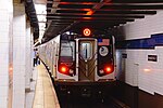 An M train at the Jackson Heights/Roosevelt Avenue station in 2014