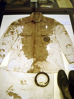Bloodied safari jacket, pants (folded), belt, and boots worn by Aquino upon his return from exile are on permanent display at the Aquino Center in Tarlac. Ninoy's bloodied jacket, belt and boots.JPG