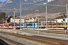 Train station Aigle with trains of AOMC, ASD und AL (from left to right)