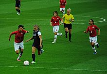 Morgan challenges Japanese defender Saki Kumagai for the ball as Mizuho Sakaguchi (6) and Azusa Iwashimizu (3) look on during their gold medal match at the 2012 Summer Olympics. Women's Soccer - USA vs Japan (1).jpg