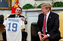 Brazilian Former President Jair Bolsonaro, sometimes called the "Tropical Trump", with United States President Donald Trump Bolsonaro with US President Donald Trump in White House, 19 March 2019.jpg