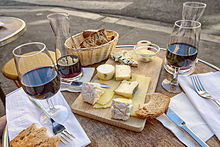 Cheese, wine and bread in a sidewalk cafe in Paris, June 2015.jpg