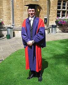 A doctor of philosophy of the University of Oxford, in full academic dress Dphil gown.jpg