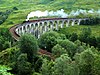 Heritage steam train crossing Glenfinnan viaduct