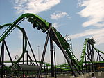 Green roller coaster preparing to go upside-down