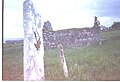 The headstone on the saint's grave and the ruins of his old church.