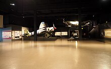Aircraft on display at the Memorial Building's Aircraft Hall. Korean War display in the AWM aircraft hall May 2021.jpg
