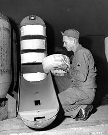 SFC Furl A. Krebs loads an M16A1 cluster adapter at the FEC (Far Eastern Command) Printing Plant, Yokohama, Japan. The bomb type adapter will contain 22,500 psychological warfare leaflets sized 5 by 8 inches (130 mm x 200 mm). Korean War leaflet bomb.jpg