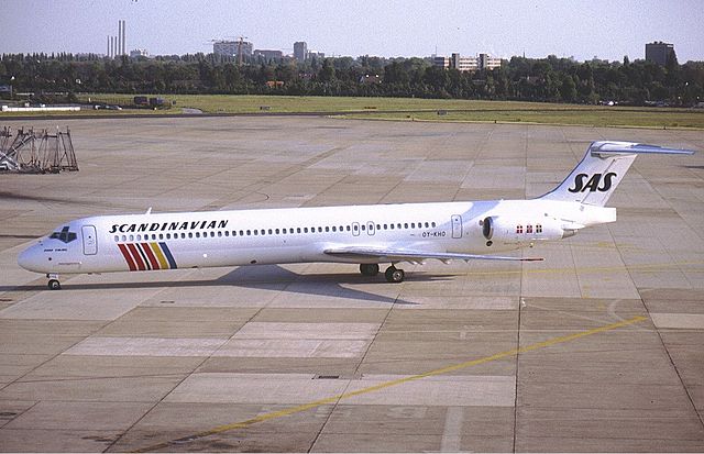 A medium jetliner with an all-white body and colored stripes