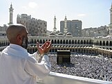 Muslim pilgrim praying in the direction of the Kaaba