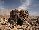 A circular ancient tomb made of cut stone