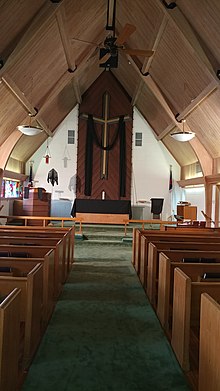 The chancel of this Lutheran church features a very large altar cross. Chancel of Grace Lutheran Church on Good Friday.jpg