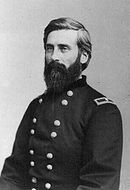 Black and white photo of a bearded man in a dark military uniform with two rows of buttons. The single star on each shoulder tab indicates that he was a brigadier general.